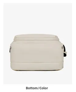 Detailed bottom view of a minimalist beige canvas business backpack with clean stitching