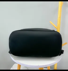 Detailed bottom view of black waterproof roll-top backpack showing durable flat base