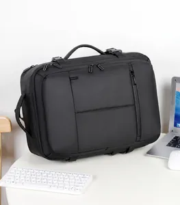 Macro detail of black expandable travel backpack with reinforced handles on office desk