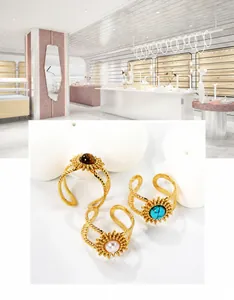 Close-up of gold-plated rings featuring turquoise, tiger eye, and pearl inzek set designs