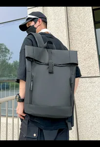 Close-up of waterproof matte black roll-top backpack with buckle and dual zippers