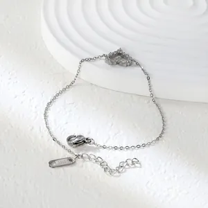 Detail of silver stainless steel heart bracelet with sparkling zircon stones and lobster clasp