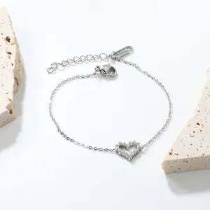 Detailed view of silver heart bracelet with zircon stones and S.STEEL engraving label