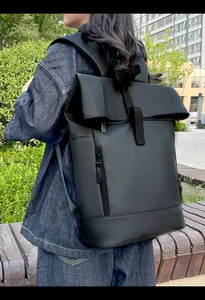 Outdoor shot of the black waterproof roll-top backpack with vertical zipper detail