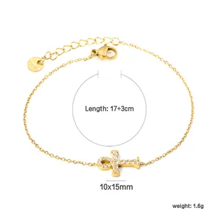 Detail view of gold heart chain bracelet with zircon cross pendant and size dimensions
