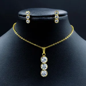Close-up of elegant stainless steel necklace and earring set with white stones