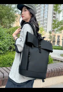 Close-up of waterproof roll-top backpack with side view on a model in urban setting