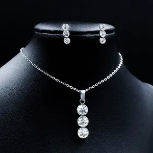 Detailed view of silver stainless steel jewelry set with three crystal stone pendants