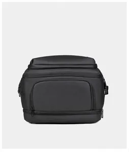 Close-up of the expandable bottom zipper compartment on the black nylon travel backpack