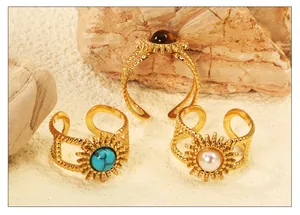 Detail of three vintage sunburst rings with turquoise and pearl on natural rock