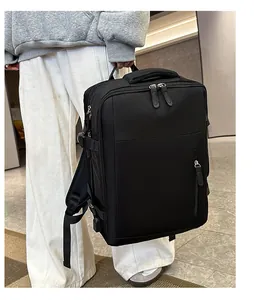 Side view of a black waterproof business travel backpack with multiple zip compartments