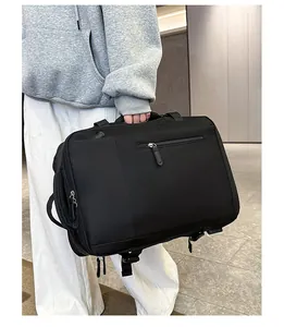 Detail of waterproof black travel backpack with side handle and bottom buckle straps