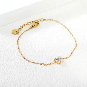 Elegant gold stainless steel link bracelet featuring a heart-shaped zircon gemstone