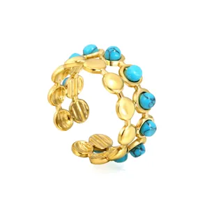Vintage style double-layered gold open ring with turquoise stones on white background
