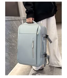 Detail of light blue business travel backpack with side handles and compression straps