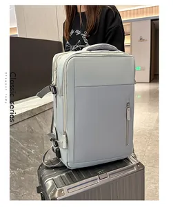 Close-up of gray travel backpack with USB port, side buckle and padded handle detail