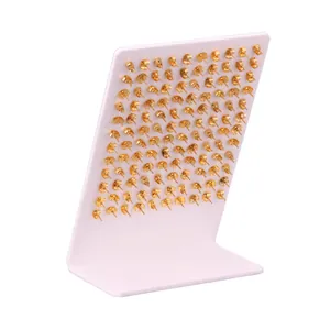 Bulk gold butterfly earring backs arranged on display board for jewelry supplies