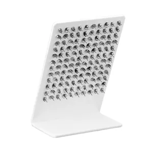 Detailed view of silver butterfly earring backs arranged on a white display board