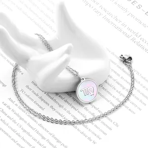 Macro view of Virgo constellation necklace with white shell inlay on a ceramic display