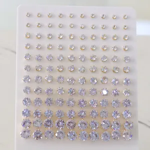 Set of sparkling round zircon stud earrings in various sizes on a white display card