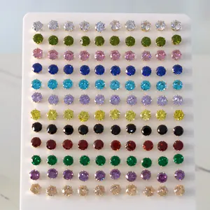 Close-up of multi-colored round cubic zirconia stud earrings in a professional display set