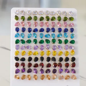 Macro view of 60 pairs of pear-cut crystal stud earrings in 12 vibrant colors on a display
