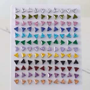 Macro detail of 120-piece set of triangle cut colorful cubic zirconia stud earrings