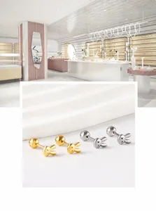 Detailed macro view of cute rabbit-shaped stud earrings in polished gold and silver finishes