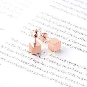 Minimalist rose gold cube stud earrings with polished geometric steel finish