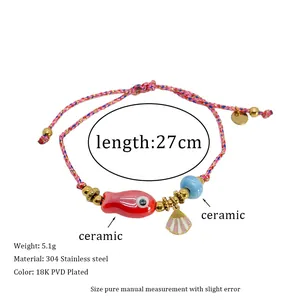 Detail of woven bracelet with ceramic fish, shell charm, and PVD gold plating measurements