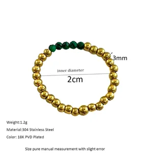 Detail view of 3mm gold beaded ring with green stones showing 2cm inner diameter