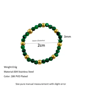 Detail of beaded ring featuring green faceted beads and 18K gold plated steel beads