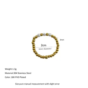 Detail of 18K gold-plated stainless steel stretch ring with white pearls and size markings