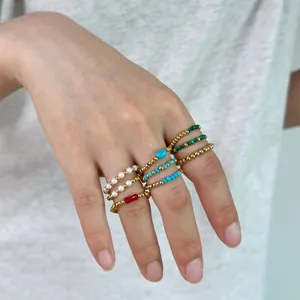 Detail of beaded rings with 18K gold stainless steel and natural stones on model