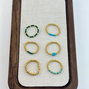 Detail of 6 beaded elastic rings with natural green stones and 18K gold-plated beads