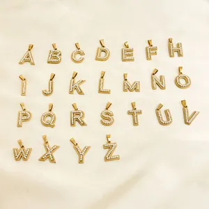 Gold A-Z initial pendants with inlaid pearls on silk background for DIY jewelry