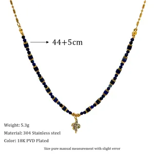 Detail view of 18K PVD gold plated 304 stainless steel necklace with blue beads and charm