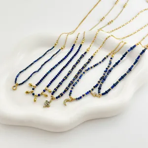 Close-up of lapis lazuli beaded necklaces with gold crescent moon and star pendants