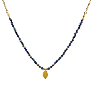 Lapis lazuli beaded necklace with a golden leaf pendant on a white background