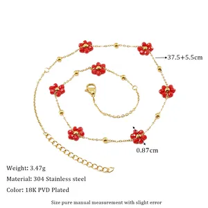 Detail of 18K gold-plated stainless steel chain with small red beaded flowers