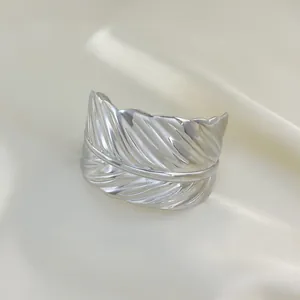Retro stainless steel wide feather cuff bracelet with detailed texture in silver