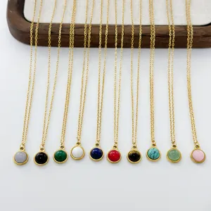 Flat lay of gold round natural stone necklaces in ten different vibrant gemstone colors