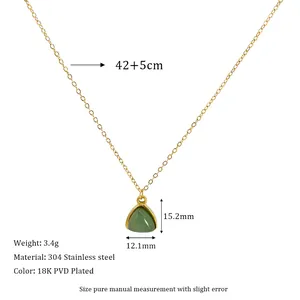 Macro detail of geometric triangle green stone pendant on 18K gold plated chain