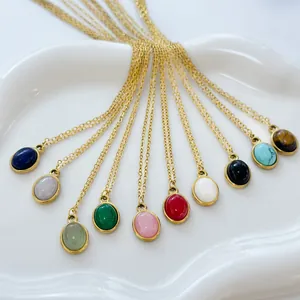 Minimalist 18K gold chain necklace with ten colorful oval natural stone pendants on white ceramic