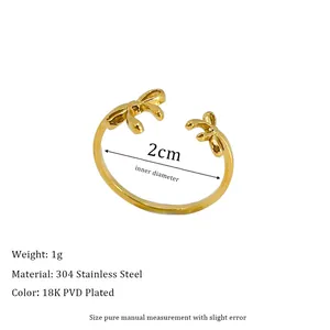 Detail of 18K gold plated stainless steel open ring featuring a delicate bow design