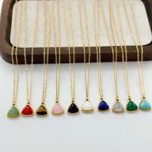 Collection of geometric triangle pendant necklaces in various natural stone colors