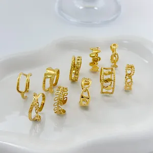 Set of 10 minimalist 18K gold plated stainless steel rings displayed on white ceramic tray