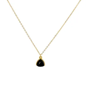Minimalist gold chain necklace featuring a geometric black triangle stone pendant
