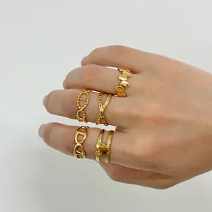 Detailed view of 18K gold plated stackable rings with heart and geometric patterns