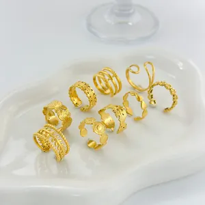 Set of 9 gold-plated stainless steel stackable rings with textured geometric patterns